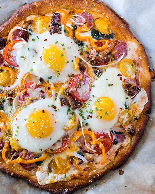 Breakfast Pizza Topped With Eggs, Sausage, Cheese, Bacon And Yellow ...