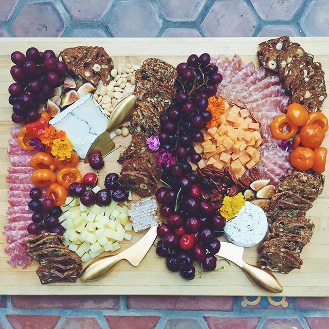 Cheese Board With Fruit, Crackers, Nuts And Charcuterie by