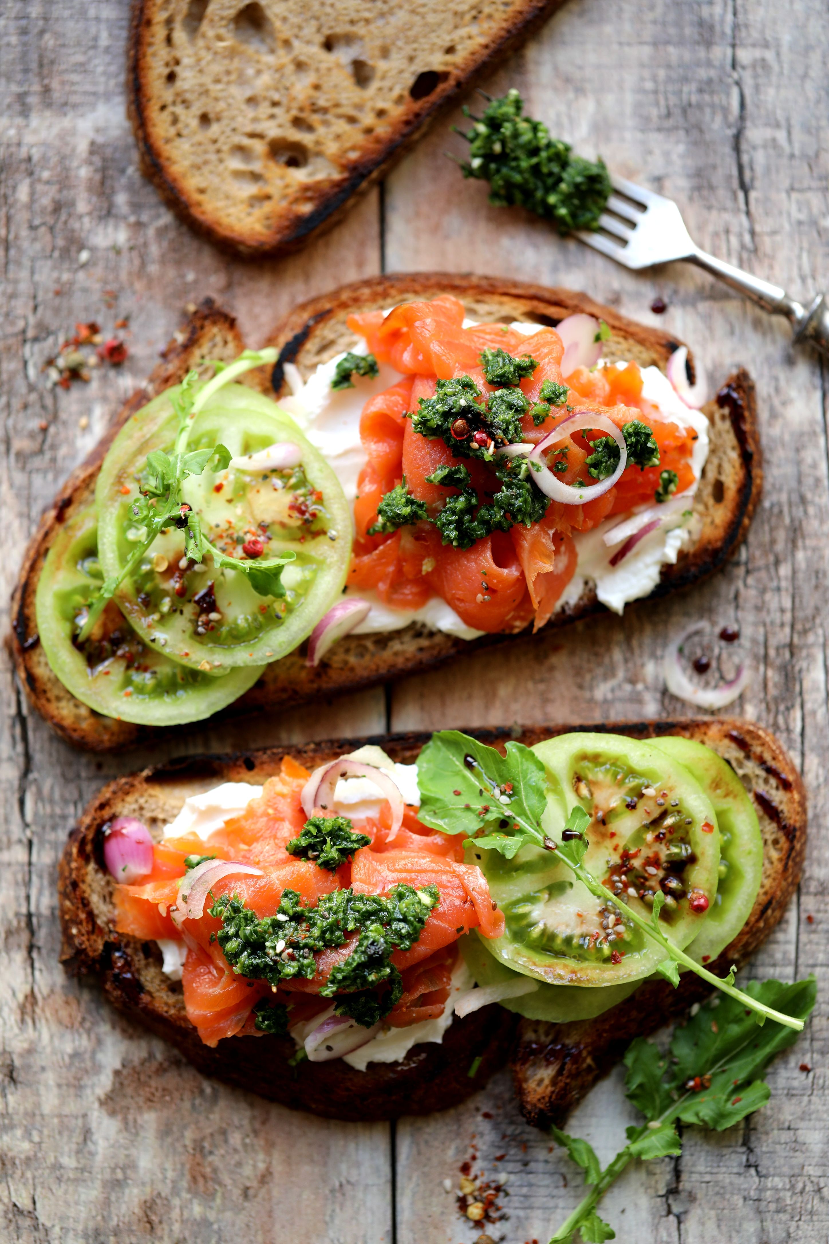 Green Tomato Smoked Salmon Toasts With Arugula And Walnut Pesto Recipe green-tomato-smoked-salmon-toasts-with-arugula-and-walnut-pesto-recipe