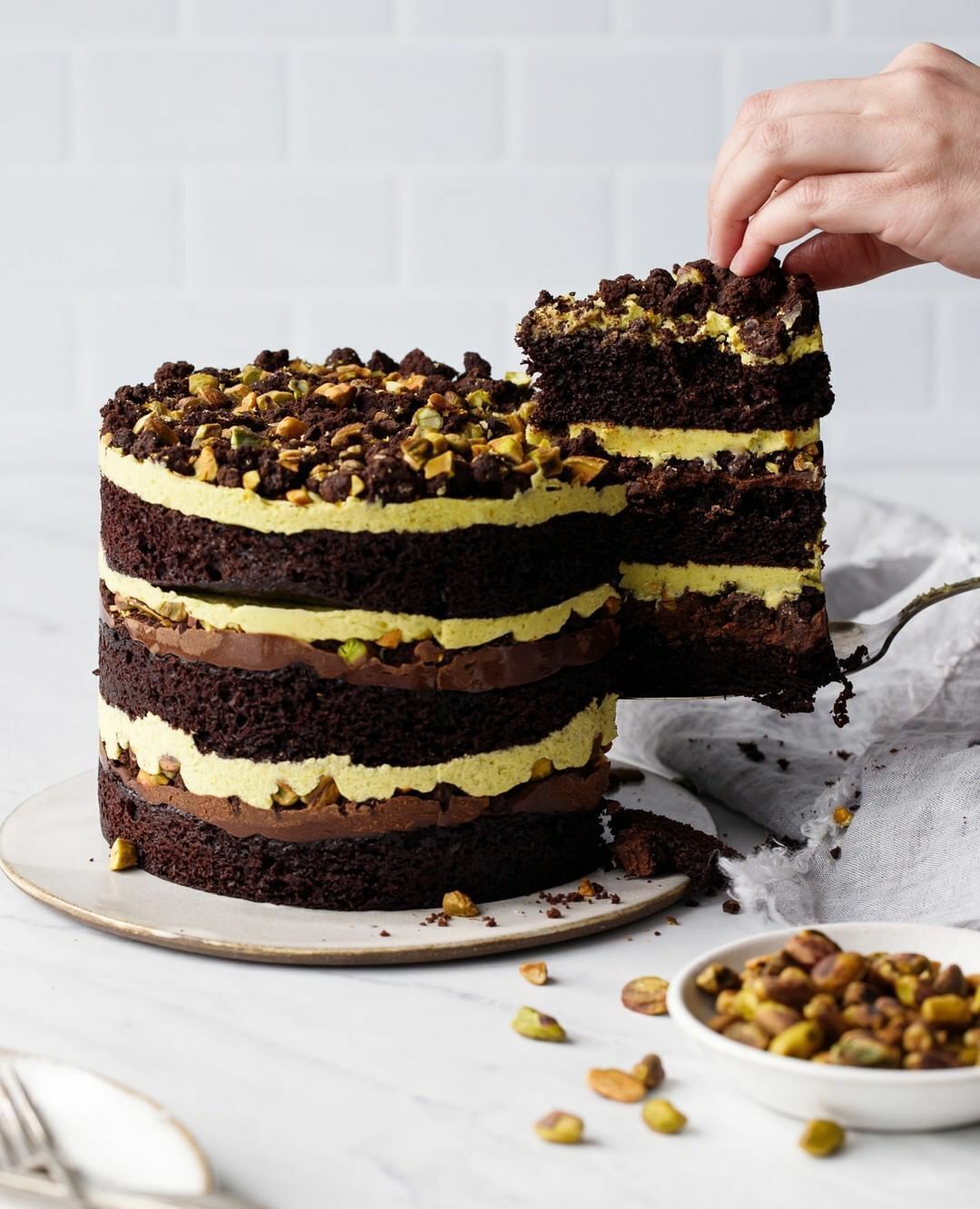 Dark chocolate pistachio layer cake with buttercream frosting.